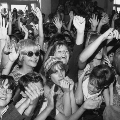 Screaming fans cheer for rock and roll musicians on 'American Bandstand' in the mid 1960s.