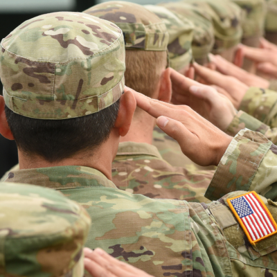 Soldiers of the U.S. Army in uniform give a salute.