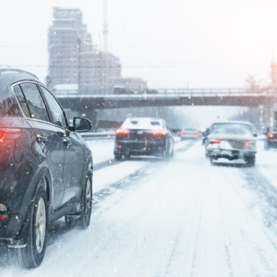Cars moving slowly on a snow-covered highway