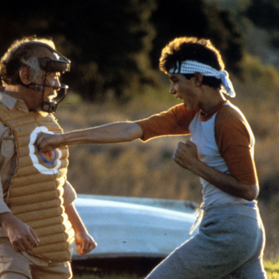 Ralph Macchio punches a dummy in a scene from the film 'The Karate Kid', 1984.
