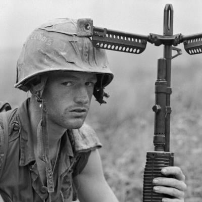 An American soldier keeps a wary eye on the hills and a firm hand on his weapon during the Vietnam War in 1968.