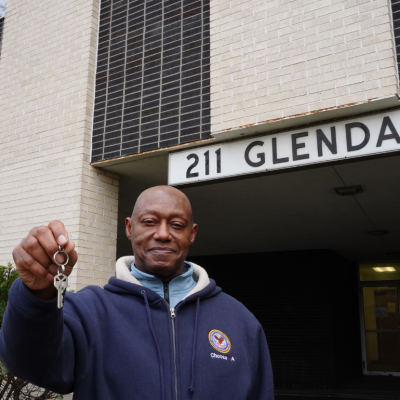 Freddie Tucker stands outside 211 Glendale, a property in Detroit that converted 60 transitional units into permanent housing units for veterans exiting homelessness.