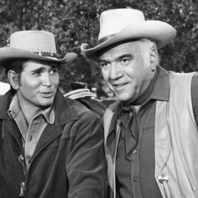 Actor Michael Landon (left) as Little Joe and actor Lorne Greene (right) as Ben Cartwright on an episode of the Western TV series 'Bonanza.'