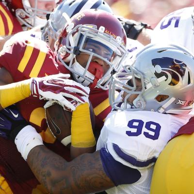 Running back Aaron Wimberly of the Iowa State Cyclones is tackled by defensive tackle Valentino Coleman of the Kansas State Wildcats in the first half of play at Jack Trice Stadium on Sept. 6, 2014 in Ames, Iowa.