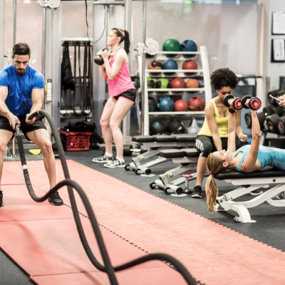five people working out in a gym on doing different exercises
