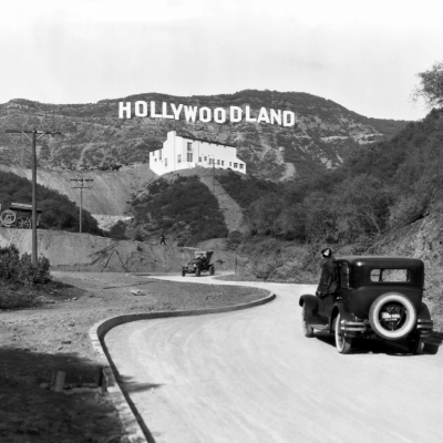 A sign advertises the opening of the Hollywoodland housing development in the hills on Mulholland Drive overlooking Los Angeles, Hollywood, Los Angeles, California, circa 1924.