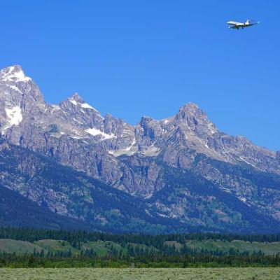 private jet approaching landing near Grand Teton mountains in Jackson Hole, WY
