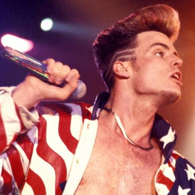 Rapper Vanilla Ice performs in an American flag jacket in 1990.