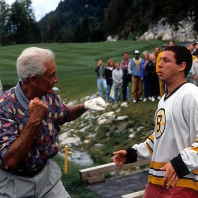 TV host Bob Barker prepares to punch comedian Adam Sandler in a scene from the 1996 film 'Happy Gilmore.'
