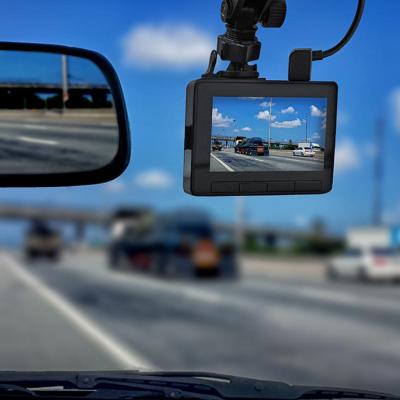 dash cam in focus showing road and sky with blurred scene in windshield