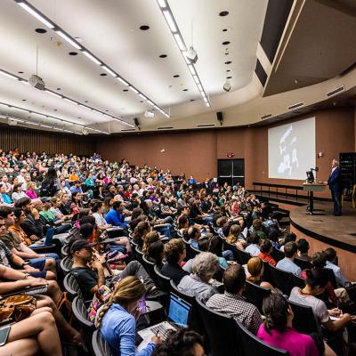 large lecture hall of students listening to professor at UT Austin