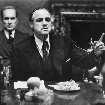 Marlon Brando as Don Vito Corleone in ‘The Godfather’; behind him is Robert Duvall as Tom Hagen, Don's lawyer.