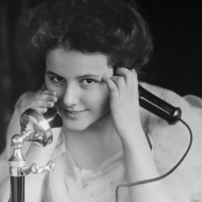 Person talking on an early telephone in 1909 in Rochester, New York.
