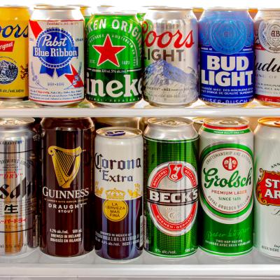 Various craft beer cans, domestic and imported from around the world, in a mini fridge.