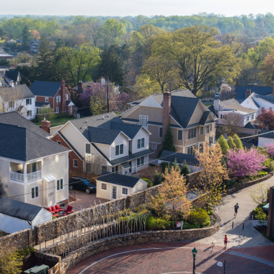  An aerial view of Chevy Chase, a wealthy suburban neighborhood in the outskirts of Washington, D.C. The sun sets behind the residential homes in the spring.
