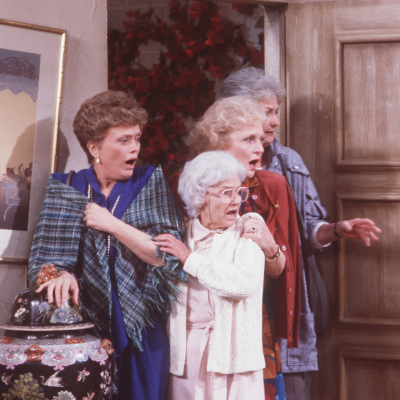 A scene from 'Golden Girls': Actors Roe McClanahan, Estelle Getty, Betty White, and Beatrice Arthur standing at a doorway looking shocked. 