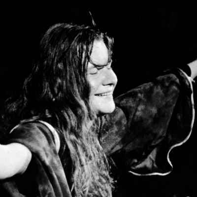 American singer Janis Joplin (1943 - 1970) closes her eyes and outstretches her arms during a performance, late 1960s. 