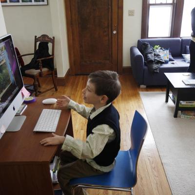 a young boy takes some time away from ABA therapy to play a game on family computer