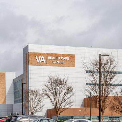 VA Healthcare center as seen from the parking lot in Charlotte, NC with overcast clouds in the background.