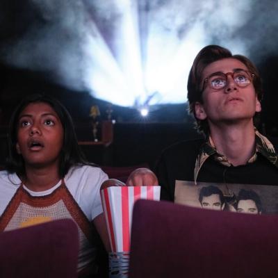 Actors Charithra Chandran and Sebastian Croft in a movie theater in the Prime Video original film 'How to Date Billy Walsh.'