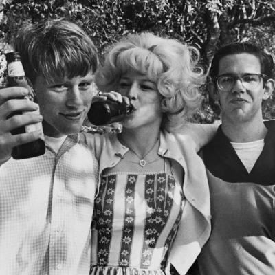 Actors Ron Howard, Candy Clark, and Charles Martin Smith in a scene from 'American Graffiti' in 1973.