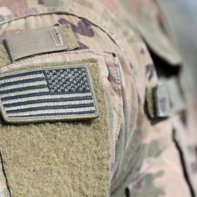 Closeup of flag on military member's uniform.