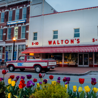 Old red and white ford truck that belonged to Sam Walton parked in front of first Walmart store which now serves as a corporate museum near the Arkansas headquarters in Bentonville