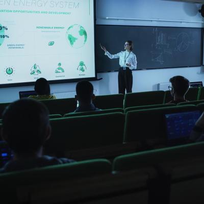 A professor in front of a class presenting about the green energy sytem.