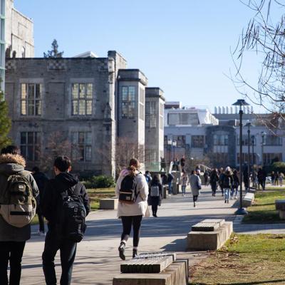 Students walking between classes in a university campus.