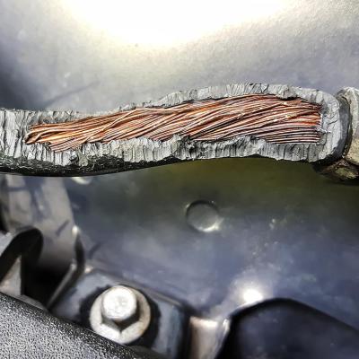 Close up of rubber over wiring in car worn away by rat chewing.