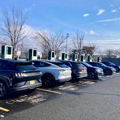 A row of electric cars charging at stations in a Walmart in New Jersey. 