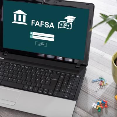 A laptop on a desk with FAFSA concept on the screen.