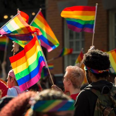 Supporters wave rainbow flags and signs at the annual Pride Parade as it passes through Greenwich Village in New York City.