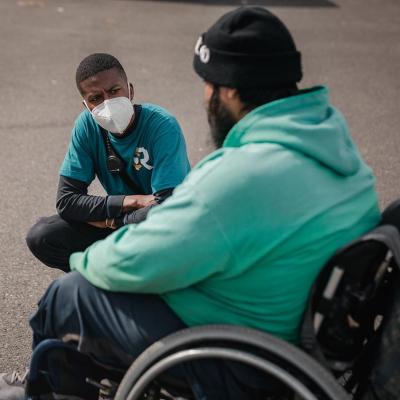 Crisis responder Chris Jones, left, talks with a community member in Olympia, WA.