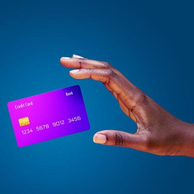 Image of a hand trying to catch a credit card mid-air.