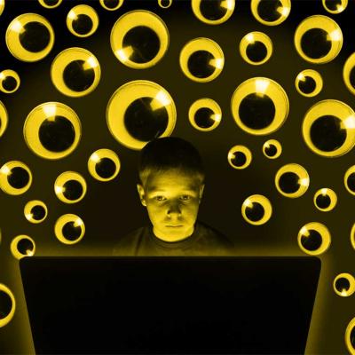 Photo illustration of student at laptop surrounded by many pairs of googly eyes watching; surveillance concept.