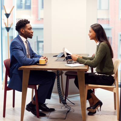 Candidate and interview sitting across from each other during a job interview.