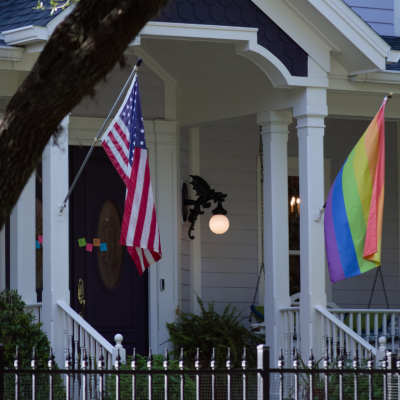 Front Porch with American flag and rainbow Pride flag