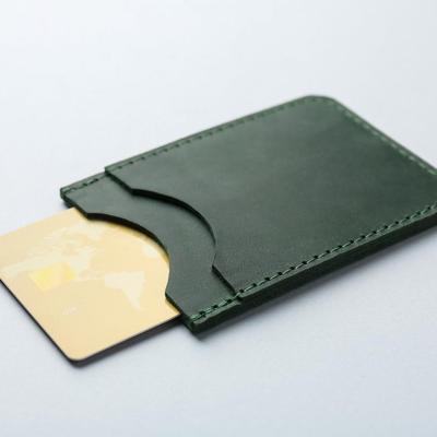 A single card inside a green wallet.