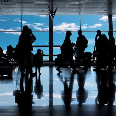 Silhouettes of people inside the airport.