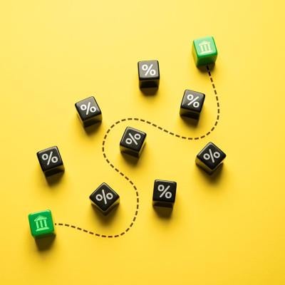 Money and stocks transfer represented by ten pieces of dice on a yellow background.