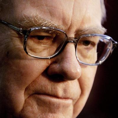 Close up photo of Warren Buffett of Berkshire Hathaway talking to members of the press at shareholders meeting.