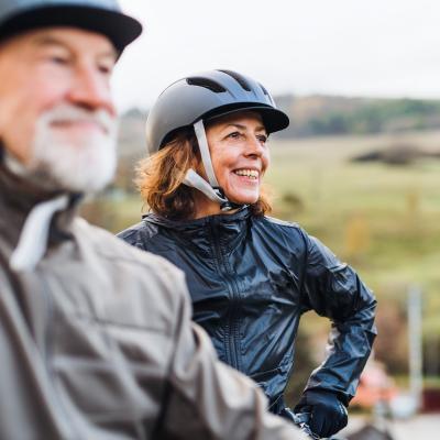 Active retired couple with bike helmets on.