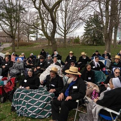 Members of the Amish community sit to watch the Solar Eclipse on April 8, 2024 in Niagara Falls, New York. 