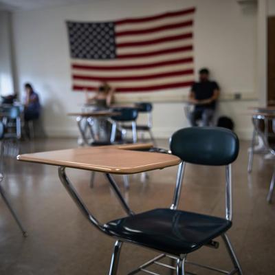 An empty chair in a sparsely attended high school classroom in Stamford Connecticut practicing hybrid learning during the pandemic.