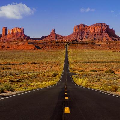 Low angle view of the road to Monument Valley heading toward desert towers.