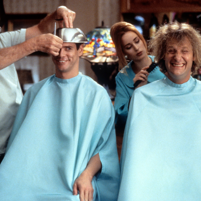 Jim Carrey and Jeff Daniels getting their hair cut in a scene from the film 'Dumb & Dumber', 1994. 