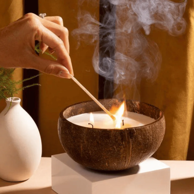 A coconut candle being lit.