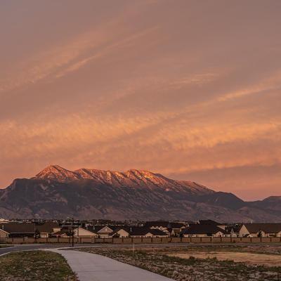 Lehi area new housing development with Utah mountains in background during sunset.