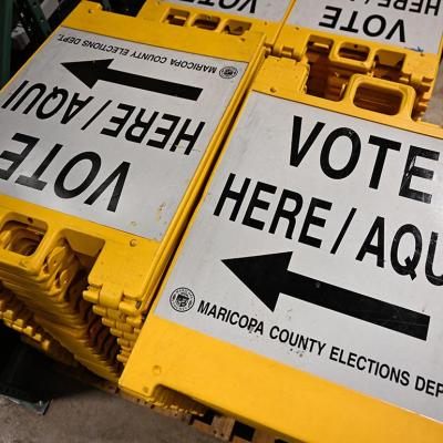 Yellow and white "Vote here" signage stored at a warehouse at the Maricopa County Tabulation and Election Center (MCTEC) ahead of the 2024 Arizona Primary. 